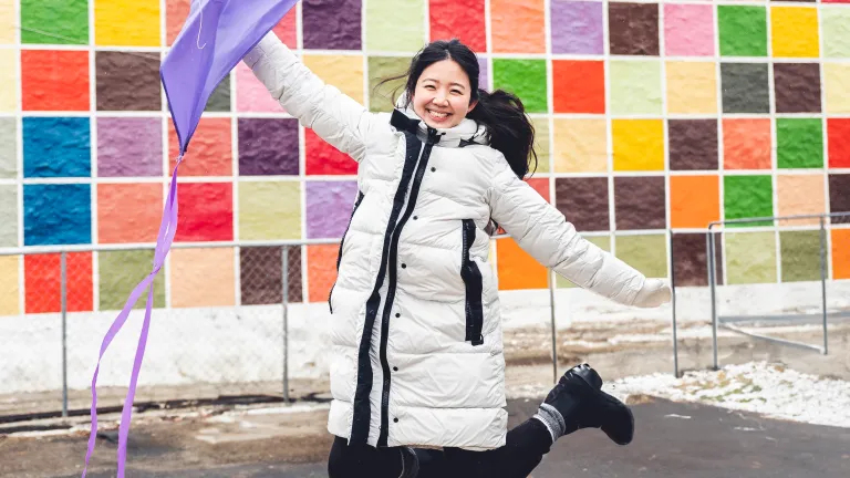 Mira kim with kite in front of colorful background wall